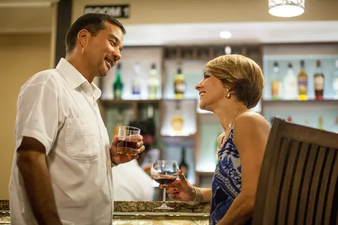 A couple sharing a drink at the bar