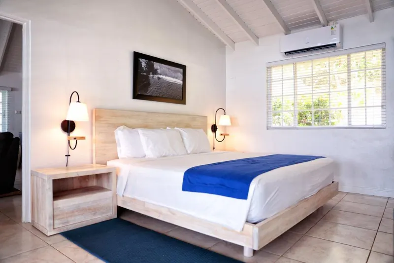 Bedroom of the One Bedroom Bungalow with a blue runner on the bed