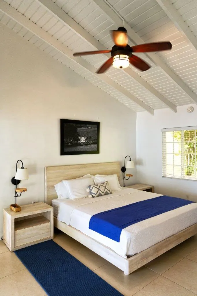 The master bedroom of Bungalow No. 9, with a king bed and a ceiling fan