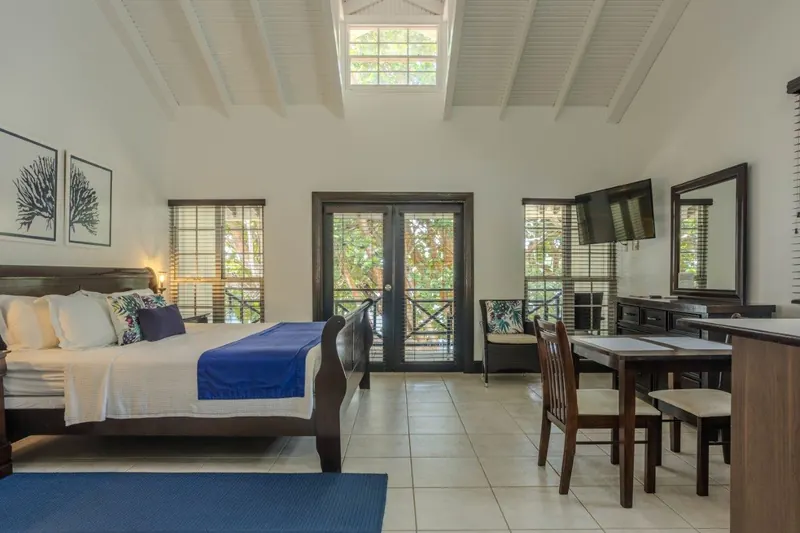 Deluxe Studio with a bed, dining table and French doors