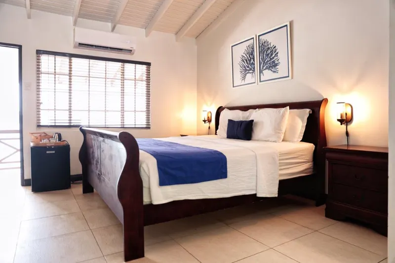 Standard Room with a bed dressed in white linen and a blue runner
